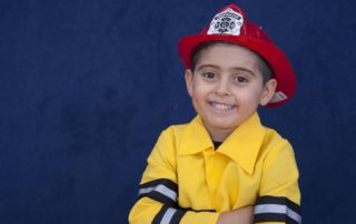 Boy with red fire helmet