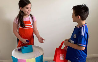 A Year 4 Holy Spirit Catholic Primary School Carnes Hill student serves a customer at her shopfront