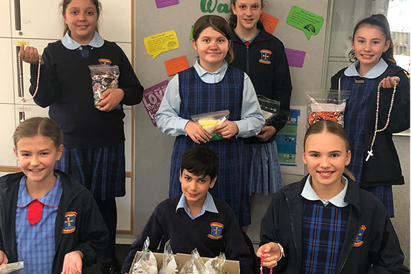 All Hallows Catholic Primary School Five Dock students with rosary beads they have made.