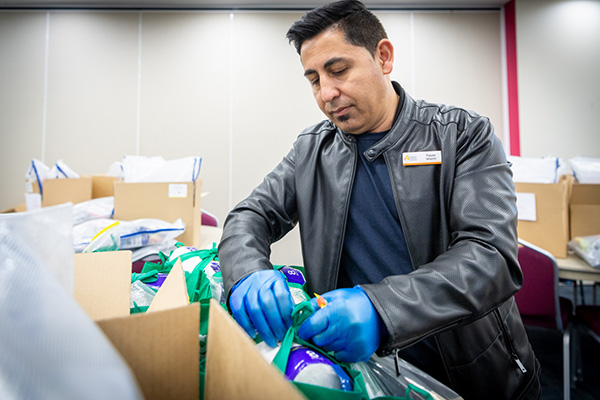 Sydney Catholic Schools Refugee and Community Liaison Officer Fayaz Wazin making education packs for refugee students.