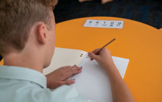 A primary school student writes in his book