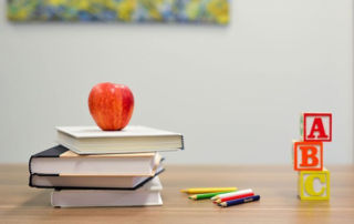 Australian-Primary-Principal's-Day apple on top of books