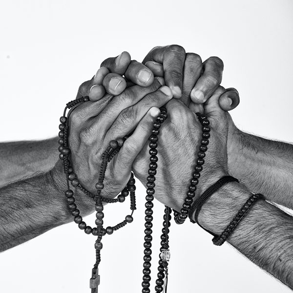 Hands holding rosary beads