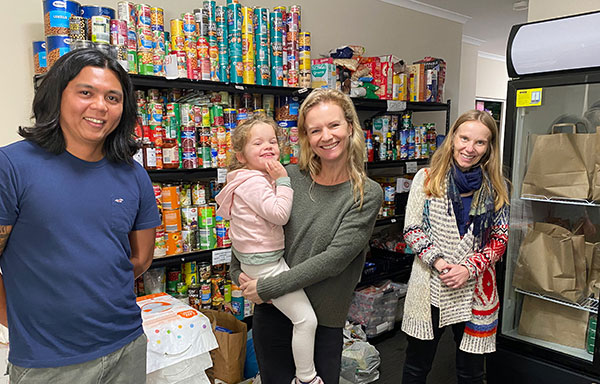 St Mary’s Primary School North Sydney parents Jaytee Agapito and Amber Quin and child with Jesuit Refugee Service director Carolina Gottardo