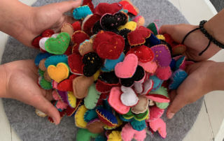 Students of Marion Catholic Primary School Horsley Park hold felt hearts made for staff at Fairfield Hospital