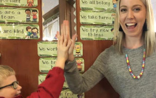 Sacred Heart Catholic Primary School Mosman Year 2 teacher, Miss Charlotte Allen high-fives a pupil