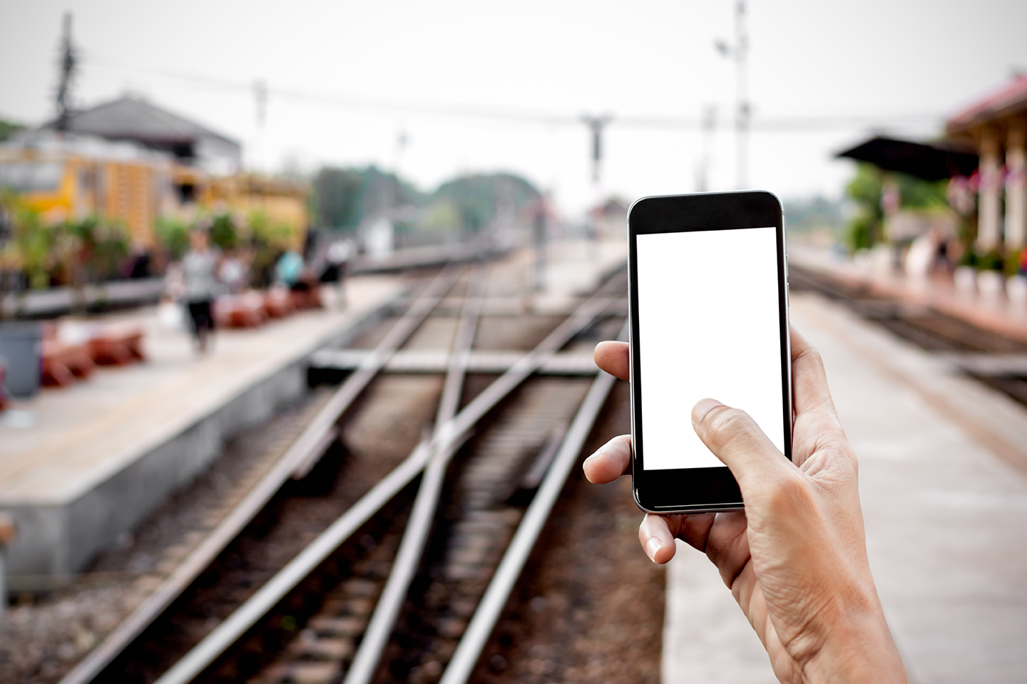 Commuter uses app at train station