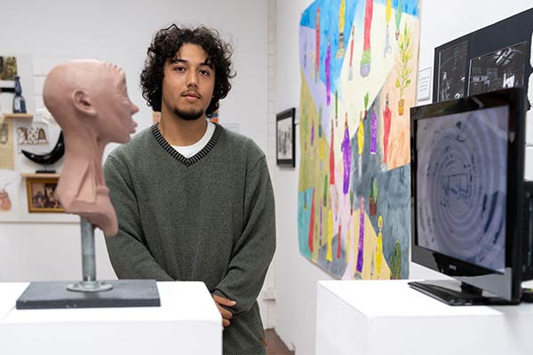 Martino Kanasugi, a former St Mary's Cathedral College Sydney student, with his Clancy Prize artwork