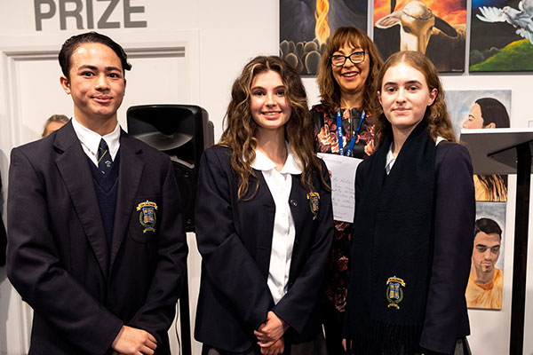 De La Salle College Cronulla students Sean Maquiran, Lily McAdam and Christina Stambolziovska accepting their Clancy Prize award