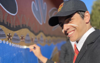 Marist College Eastwood male student helps create an Indigenous mural