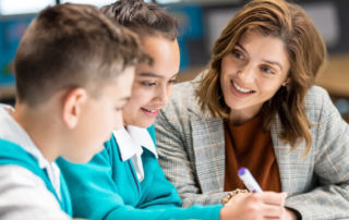 two students with a teacher