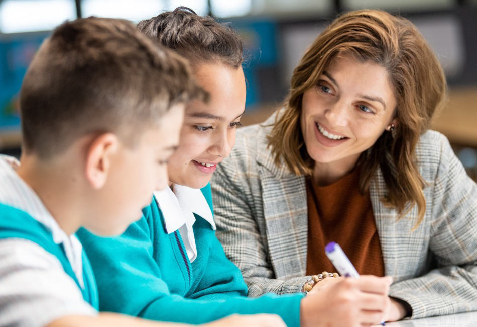 two students with a teacher