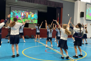 Students dance in their school hall on Feel Good Friday