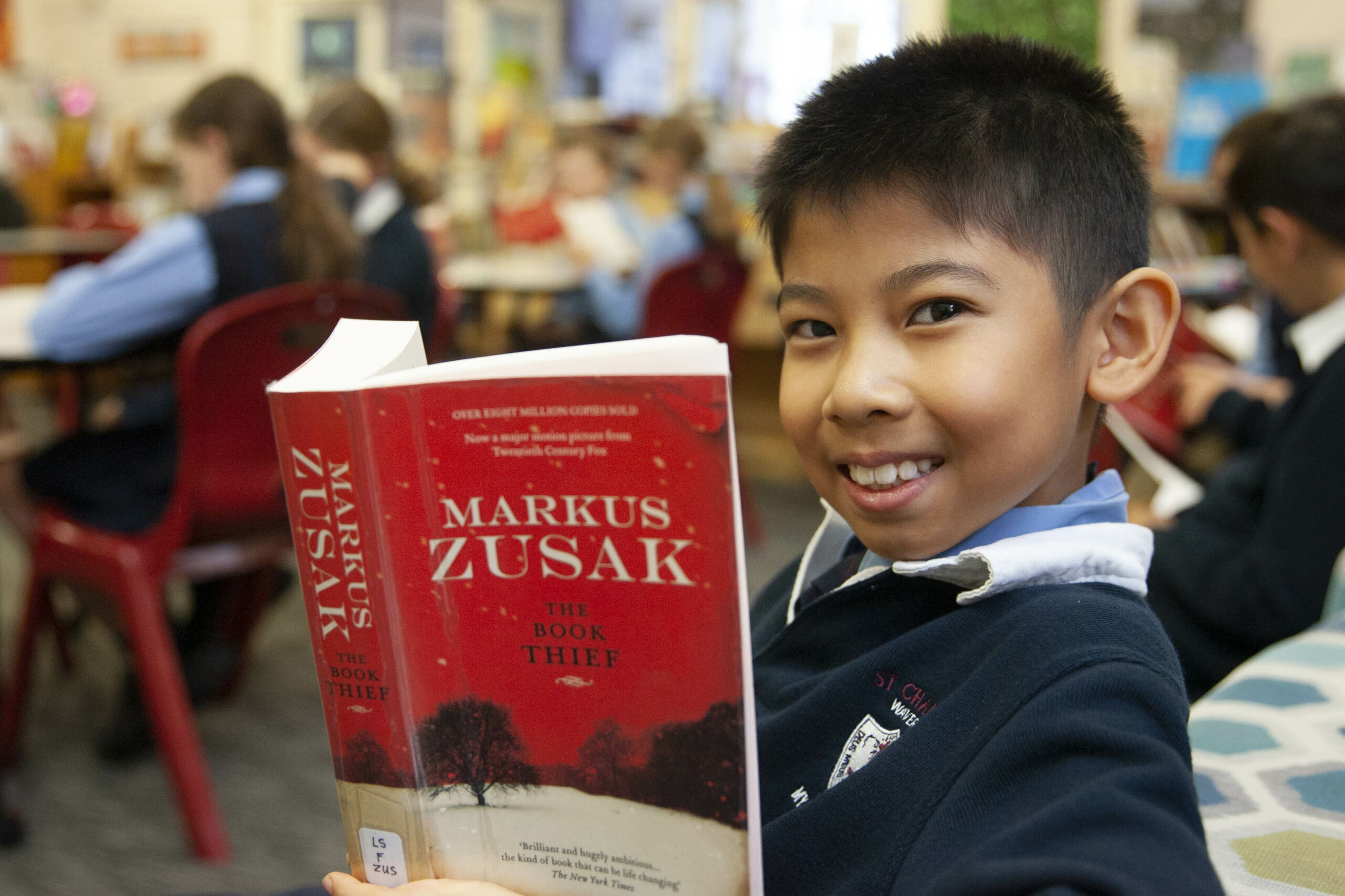 A boy from St Charles' literature enrichment group reads 'The Book Thief'