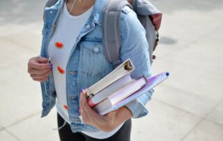 Woman holding text books